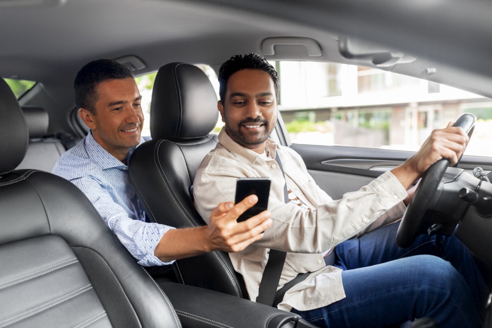 transportation, vehicle and technology concept - smiling male passenger showing smartphone to car driver. male passenger showing smartphone to car driver