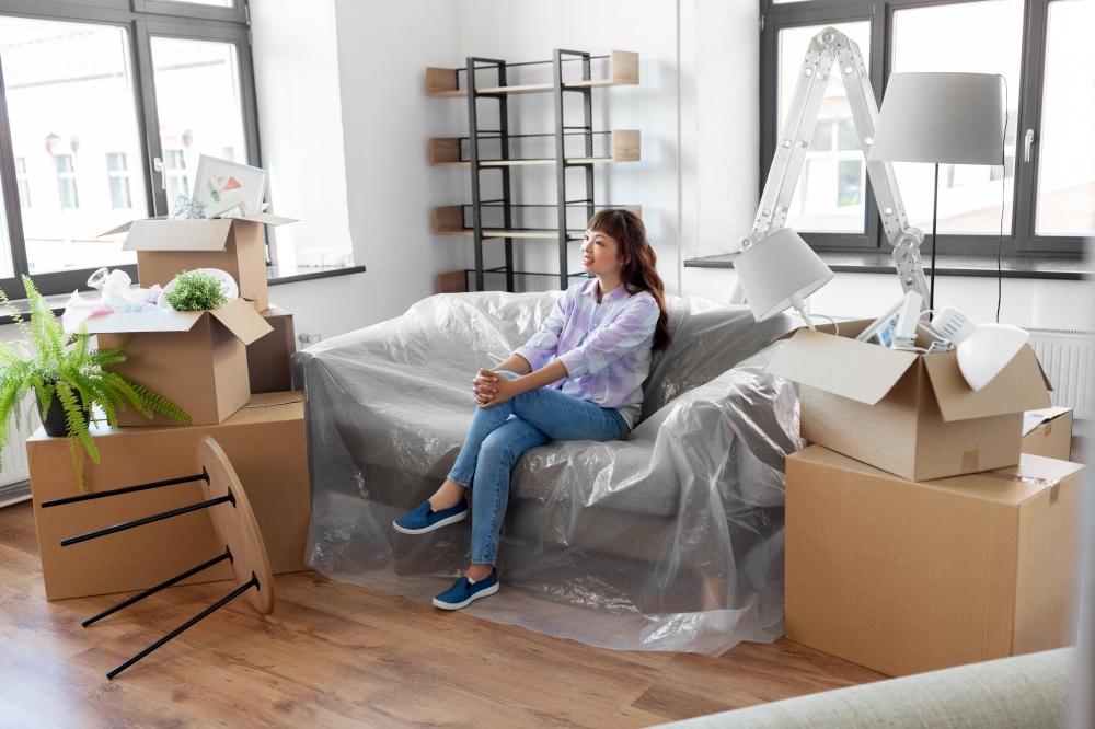 people, repair and real estate concept - happy smiling asian woman with stuff moving to new home. happy asian woman with stuff moving to new home