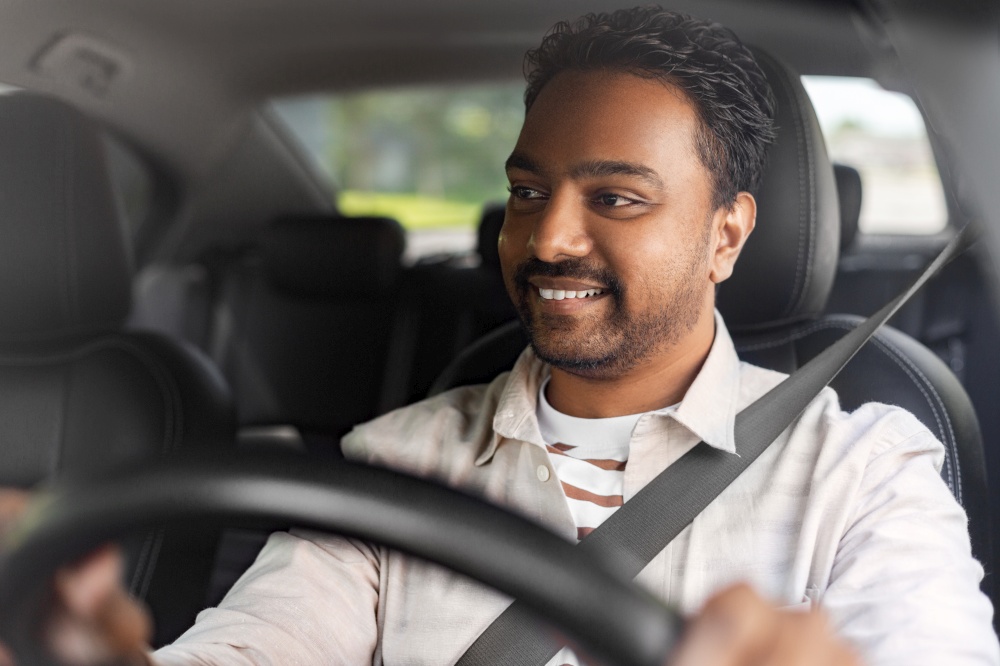 transport, vehicle and people concept - happy smiling indian man or driver driving car. smiling indian man or driver driving car