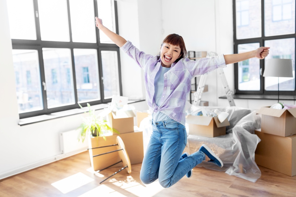 people, repair and real estate concept - happy smiling asian woman with stuff moving to new home and having fun. happy asian woman with stuff moving to new home