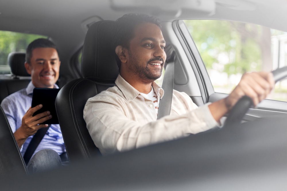 transportation, vehicle and people concept - happy smiling indian male driver driving car with passenger. indian male driver driving car with passenger