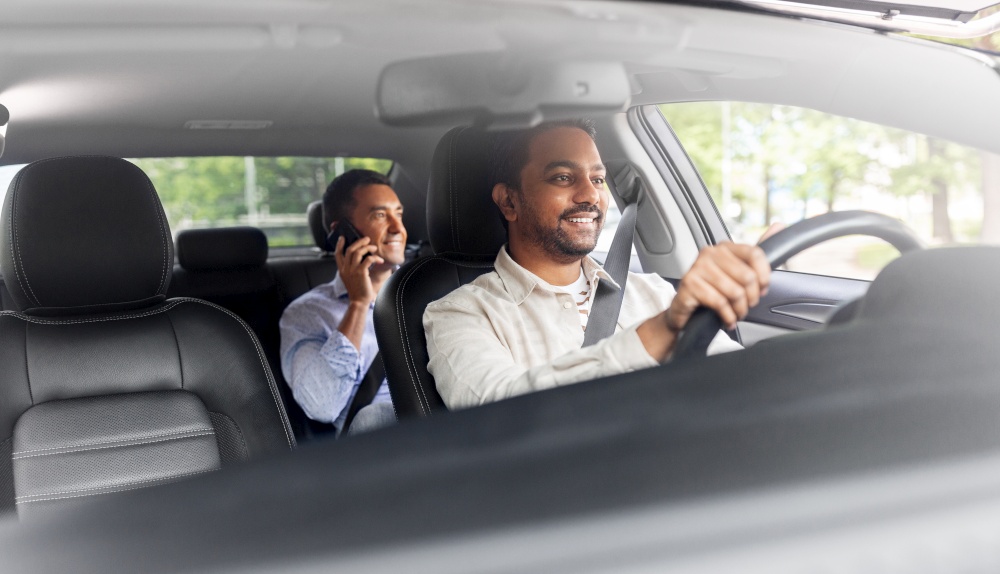 transportation, vehicle and people concept - smiling middle aged male passenger calling on smartphone on back seat and car driver. male passenger calling on smartphone in taxi car