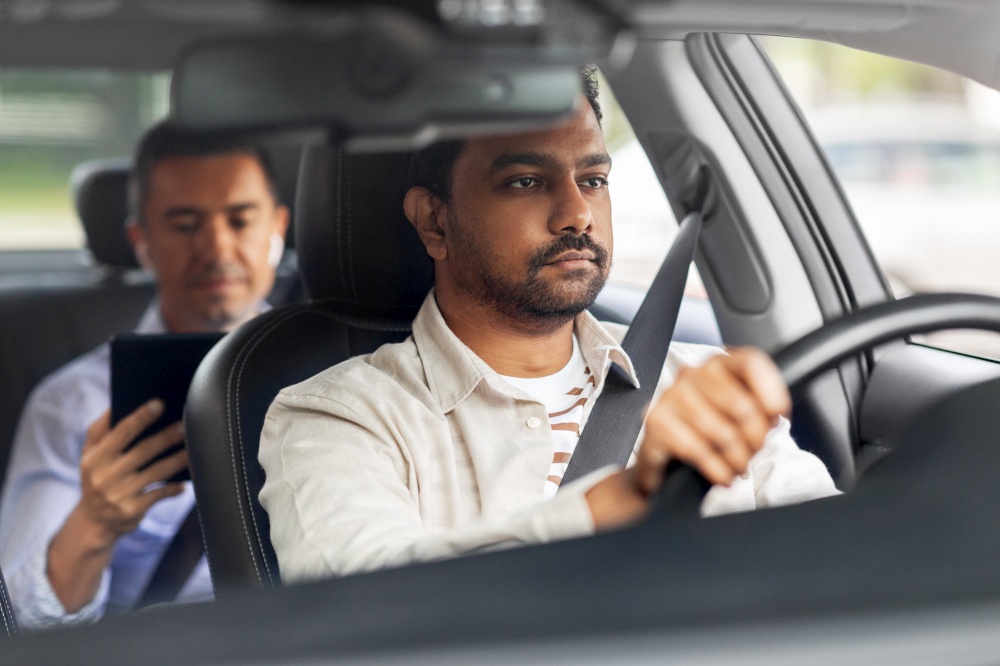 transportation, vehicle and people concept - indian male driver driving car with passenger. indian male driver driving car with passenger
