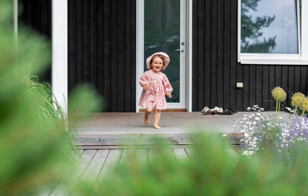 childhood, leisure and people concept - happy little baby girl having fun outdoors in summer. happy little baby girl having fun outdoors