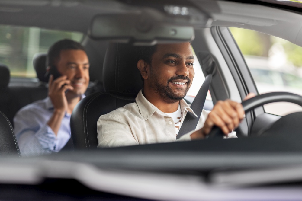 transportation, vehicle and people concept - happy smiling indian male driver driving car with passenger. indian male driver driving car with passenger