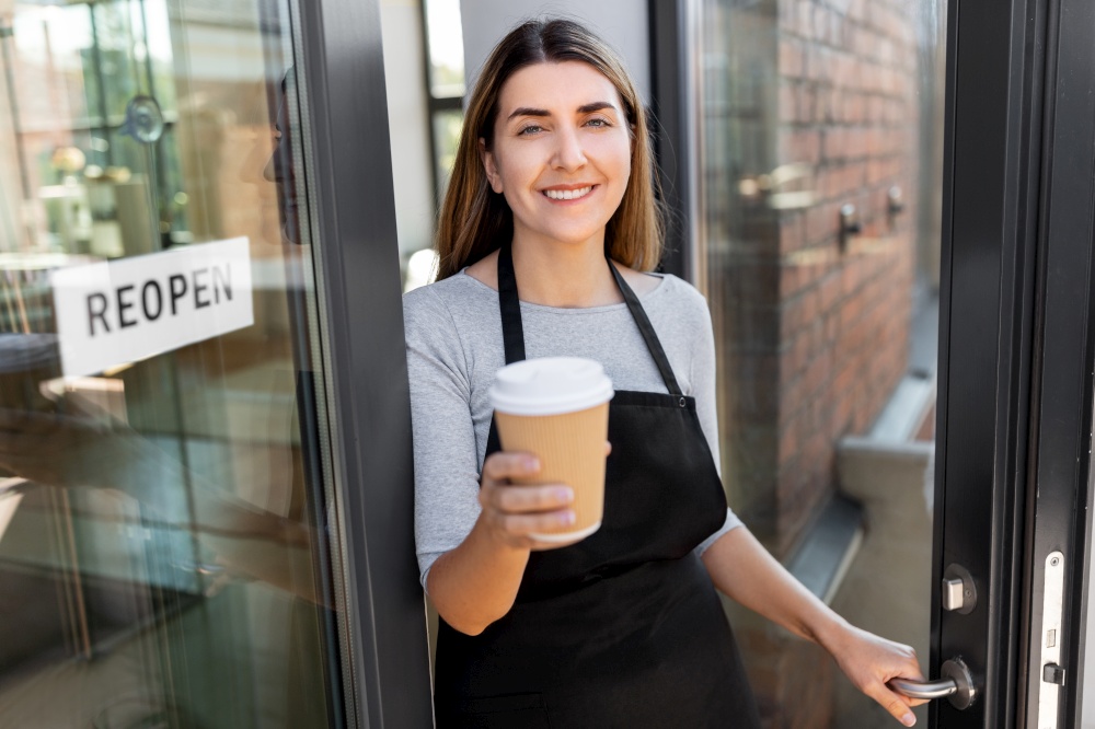 small business, reopening and service concept - happy smiling woman with takeaway coffee cup and reopen banner on window or door glass. happy woman with coffee and reopen banner on door