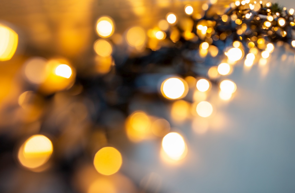 christmas, holidays and illumination concept - blurred electric garland lights. blurred electric garland lights