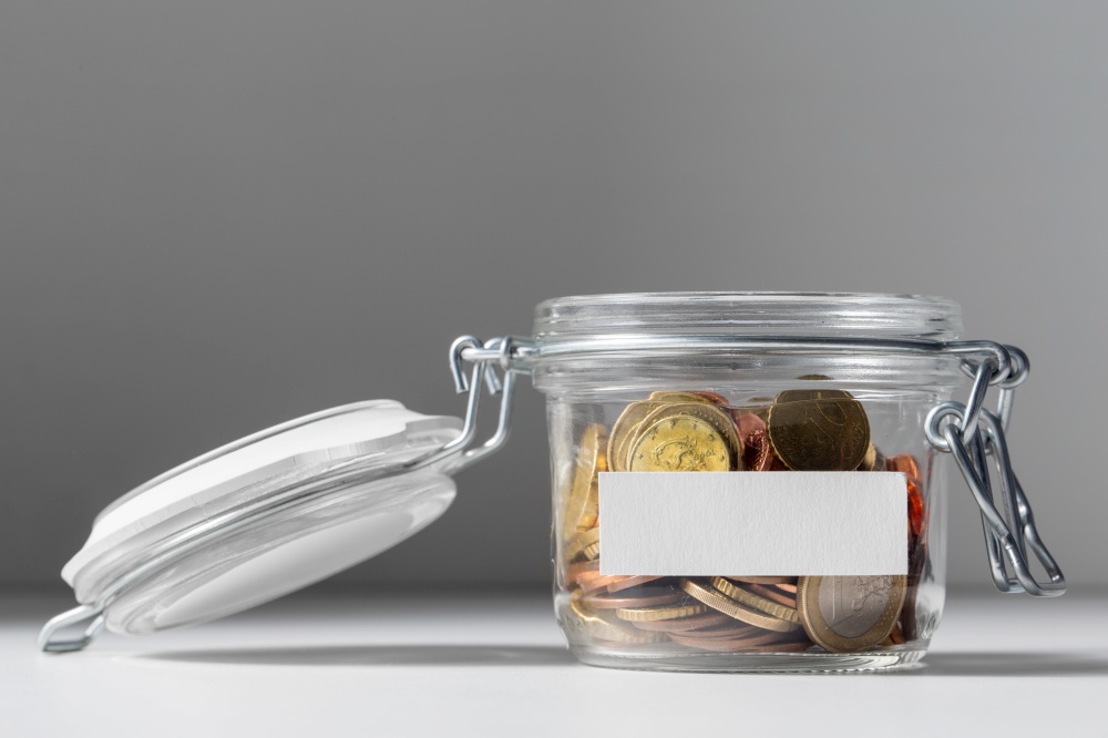 charity, donation and saving concept - close up of coins in glass jar. coins in glass jar for donation or saving