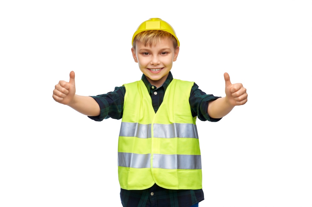 building, construction and profession concept - happy smiling little boy in protective helmet and safety vest showing thumbs up over white background. happy boy in construction helmet showing thumbs up