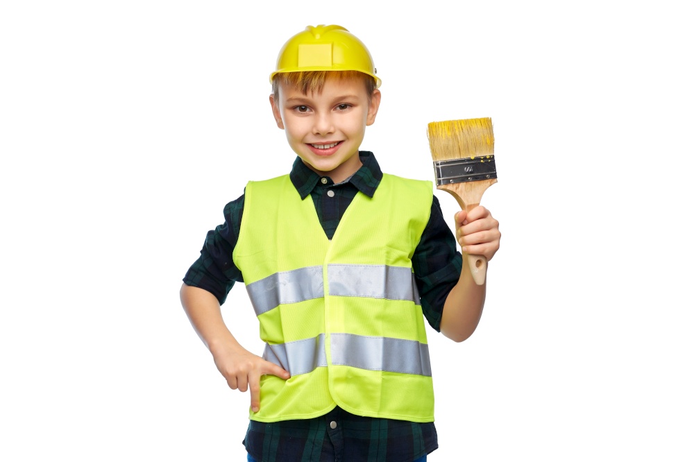 building, construction and profession concept - happy smiling little boy in protective helmet and safety vest with brush over white background. little boy in protective helmet with brush