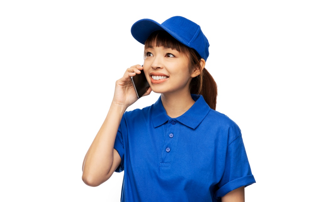 profession, job and people concept - happy smiling delivery woman in blue uniform calling on smartphone over white background. happy smiling delivery woman calling on smartphone