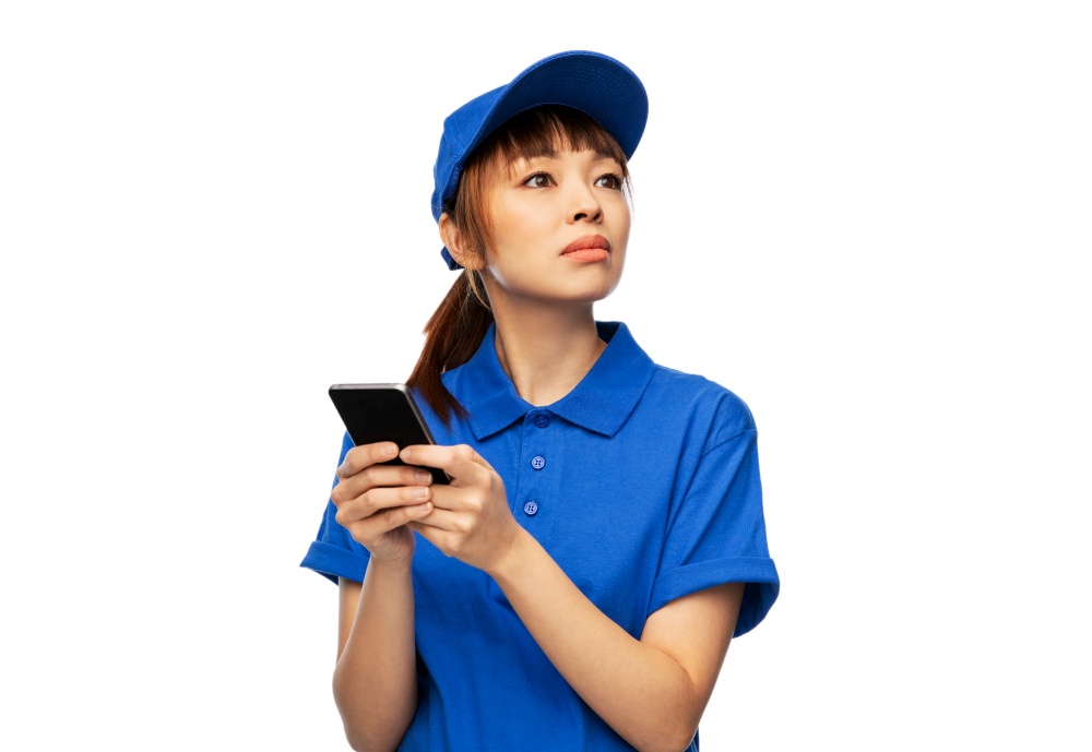 profession, job and people concept - delivery woman in blue uniform with smartphone over white background. delivery woman with smartphone