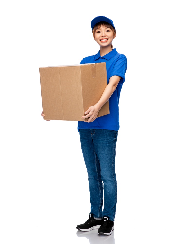 mail service and shipment concept - happy smiling delivery woman with parcel box in blue uniform over white background. delivery woman in blue uniform with parcel box