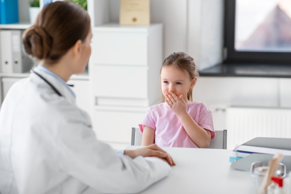 medicine, healthcare and pediatry concept - female doctor or pediatrician and coughing little girl patient on medical exam at clinic. doctor and little girl patient coughing at clinic