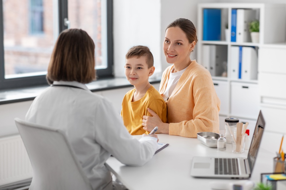 medicine, healthcare and pediatry concept - smiling mother with little son and doctor talking at clinic. smiling mother, son and doctor talking at clinic