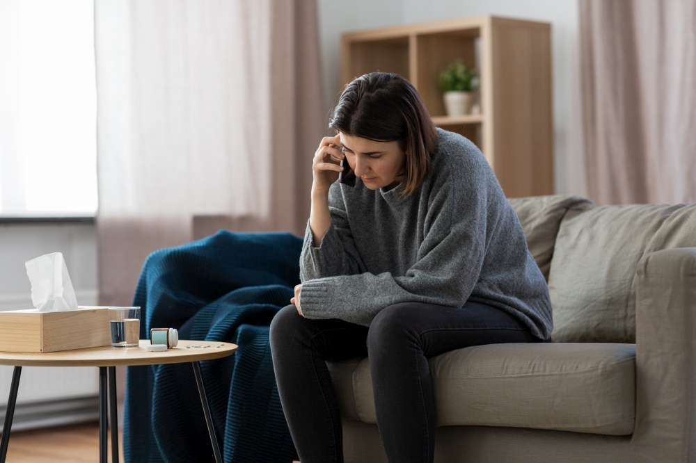 mental health, psychological help and depression concept - stressed woman with sedative medicine on table calling on phone at home. stressed woman with medicine calling on phone
