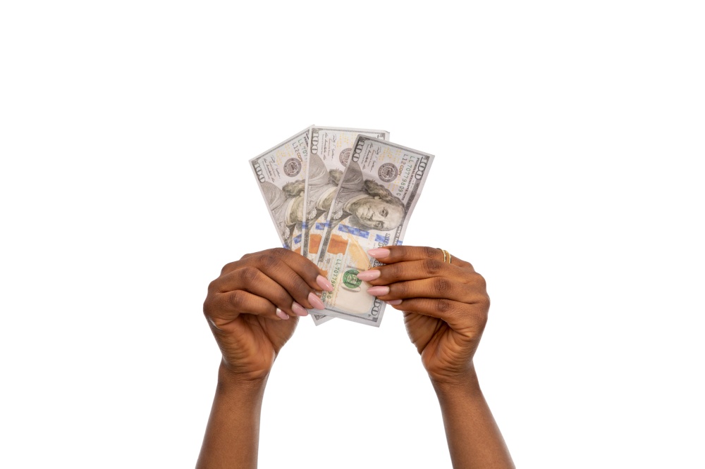 finance, currency and people concept - close up of female hands holding dollar money over white background. close up of hands holding dollar money