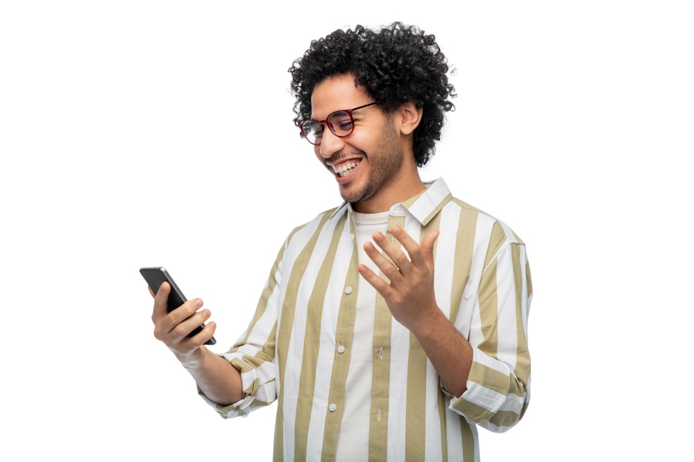 technology, communication and people concept - happy smiling young man in glasses with smartphone over white background. happy smiling young man with smartphone