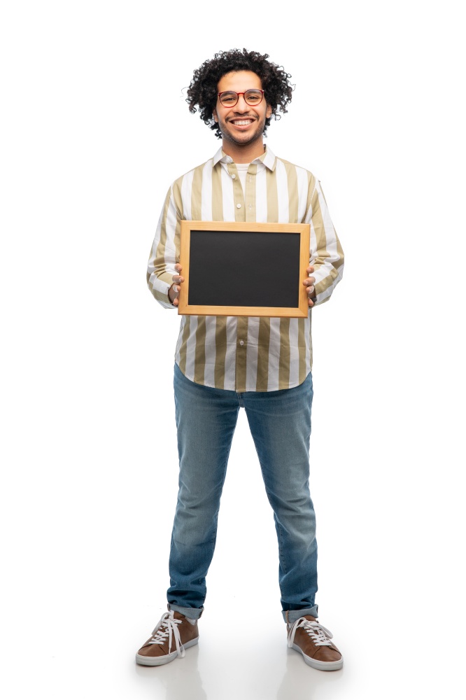 people concept - smiling young man in glasses holding chalkboard over white background. smiling man with chalkboard over white background