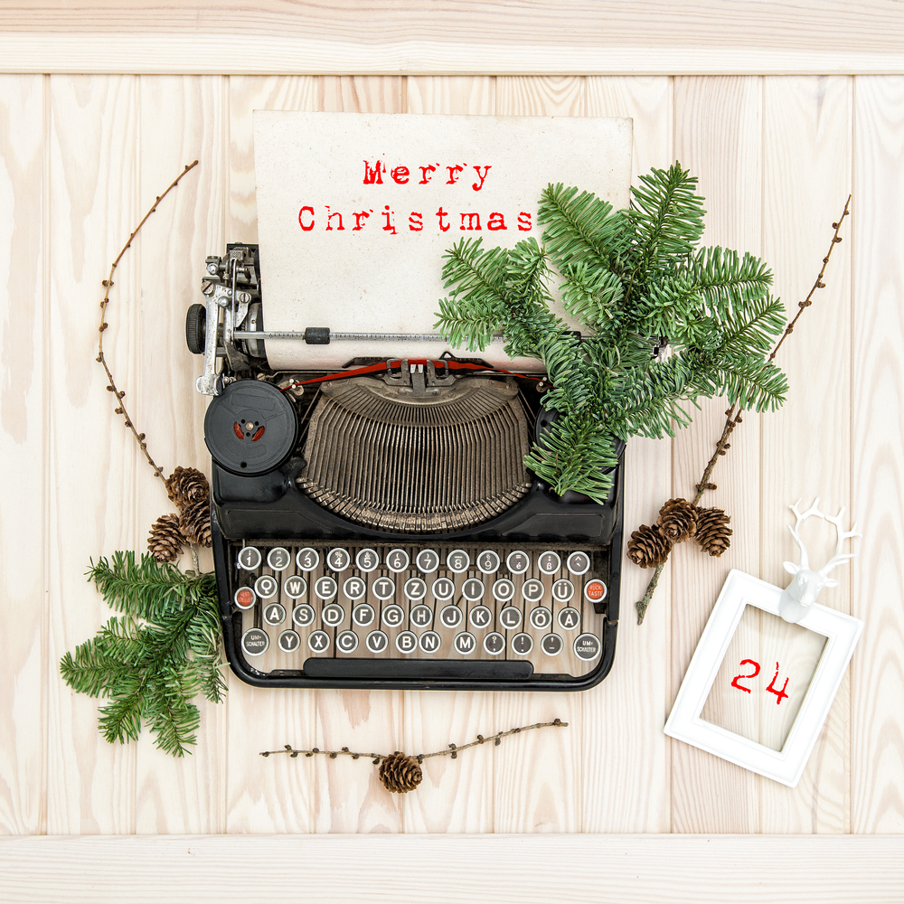 Vintage typewriter with christmas decoration evergreen tree brunches. Merry Christmas!