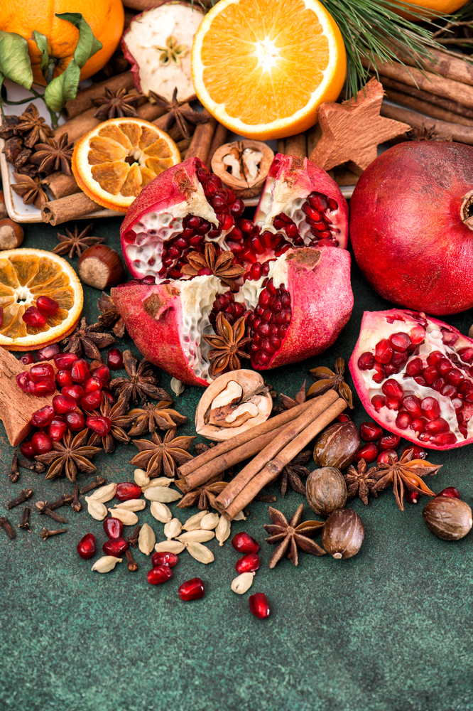 Fruits pomegranate and orange with spices and ingredients for mulled wine