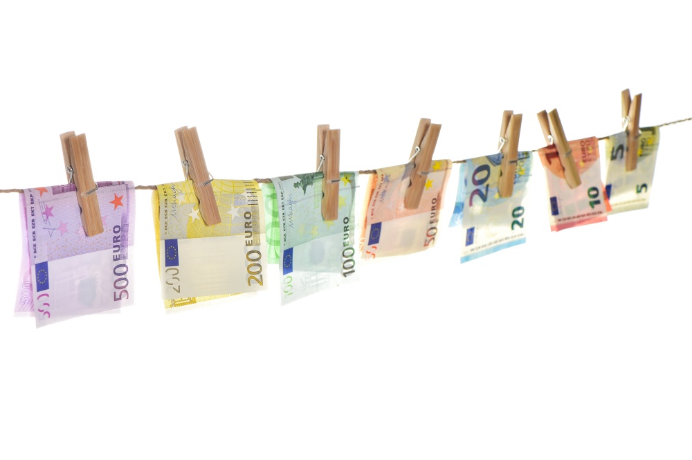 Euro banknotes hanging a rope with clothes pins. Money background. Selective focus
