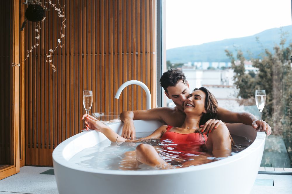 Beautiful couple enjoying a relaxing bath with champagne