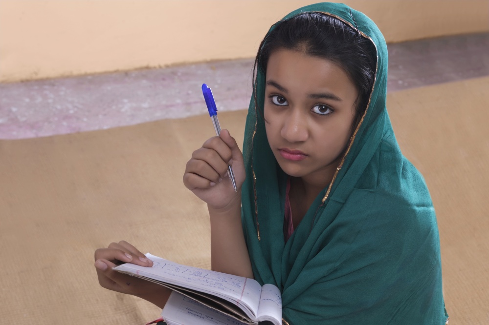 Portrait of rural girl studying