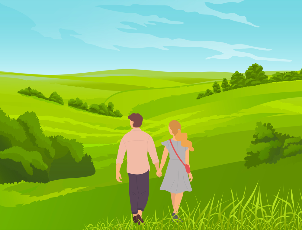 Young romantic couple walks in park or field. Grass in the foreground, bushes, thickets, valley. Walking the countryside, tourist route, picturesque landscape with young married couple or teenagers. Young couple or teenagers walk hand in hand through the green valley. Bushes and grass on background