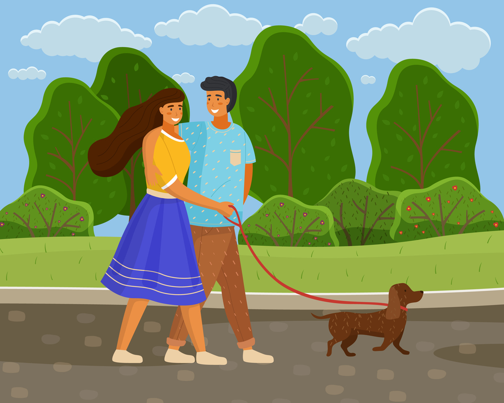 In love couple of young girl and guy wallking with dog at leash in summer park along road, happy people spend time together outdoors at nature, leisure activity, green trees and bushes at background. In love couple of young girl and guy wallking with dog at leash in summer park along road, leisure