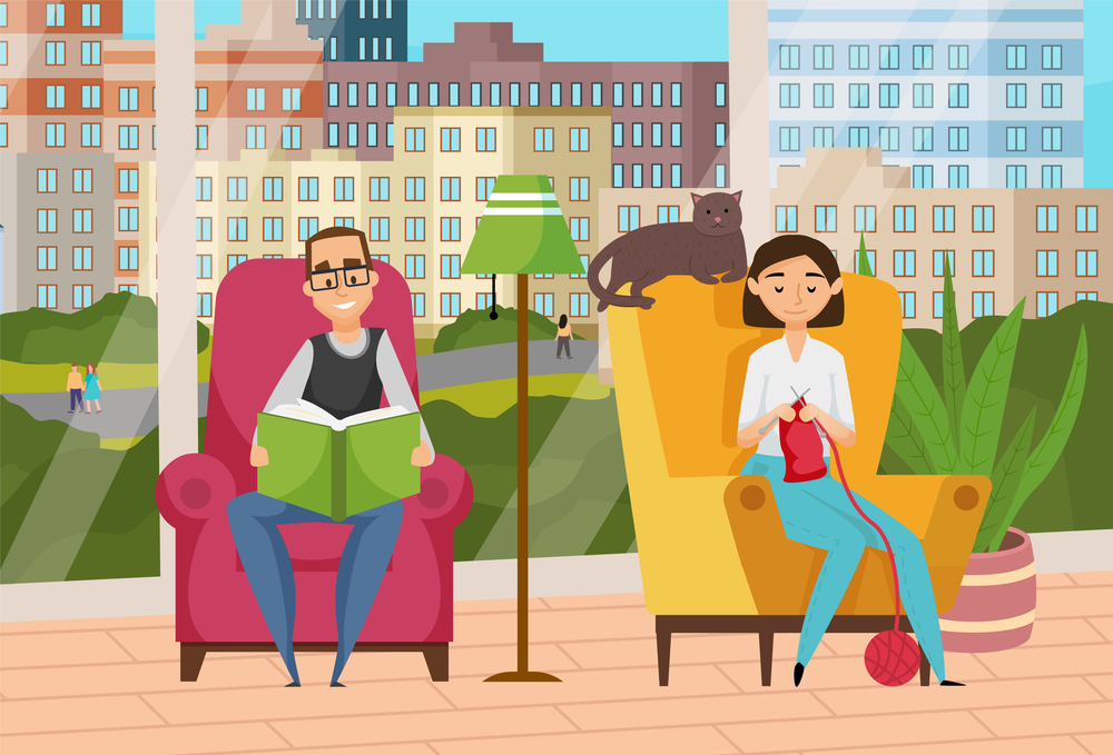 Relaxing at home, adult man and woman sitting in soft comfortable armchairs near panoramic windows, cute cat lying on chair s back, man reading book, woman knitting scarf, leisure time together. Relaxing at home, adult man and woman sitting in soft comfortable armchairs near panoramic windows