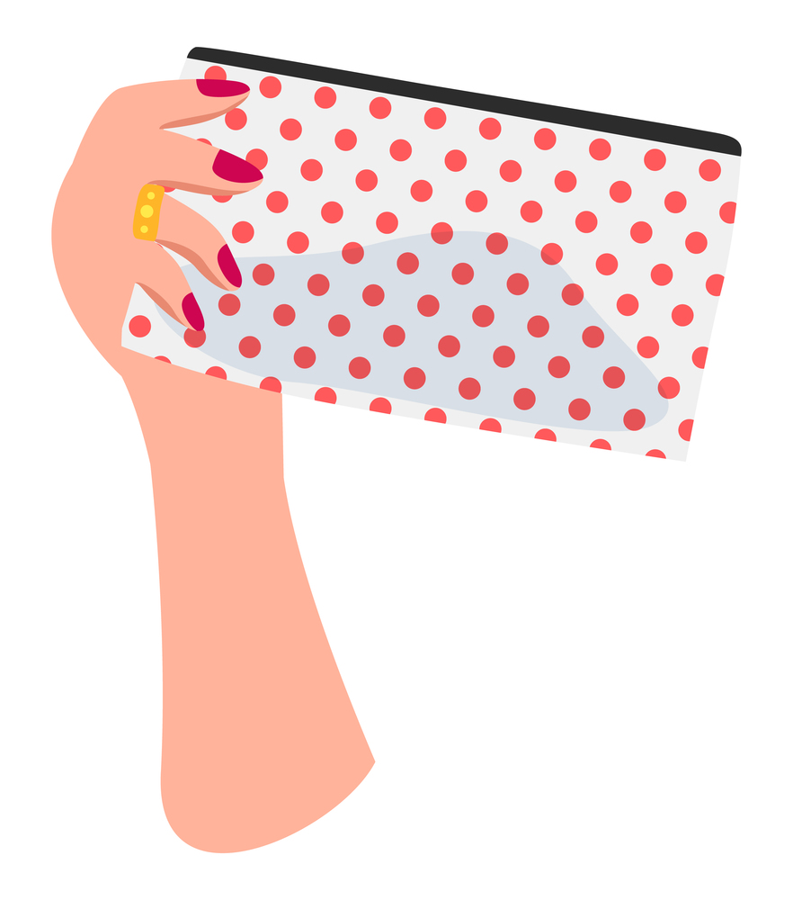 Isolated at white background white female hand with red nail polish, golden ring on finger holding dotted cosmetic bag with silhouette of cosmetics inside. Equipment of visagiste. Simple icon. Isolated white female hand with red nail polish, golden ring on finger holding dotted cosmetic bag