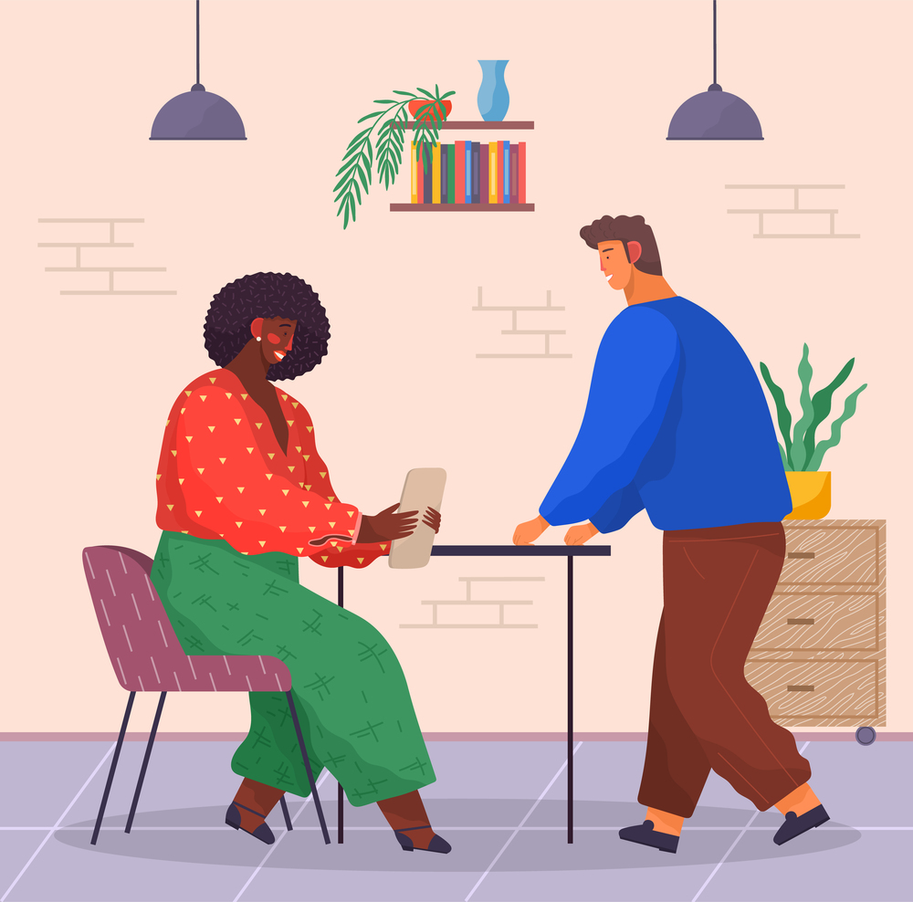 Office staff, partnership. Dark-skinned woman wears sweater, pants sits in chair with tablet. Young man in sweater and pants leaned on table. Modern office building, brick walls, plant, folders. Dark-skinned woman sits, reads sth on tablet. Man stands and waits. People in office. Office workers
