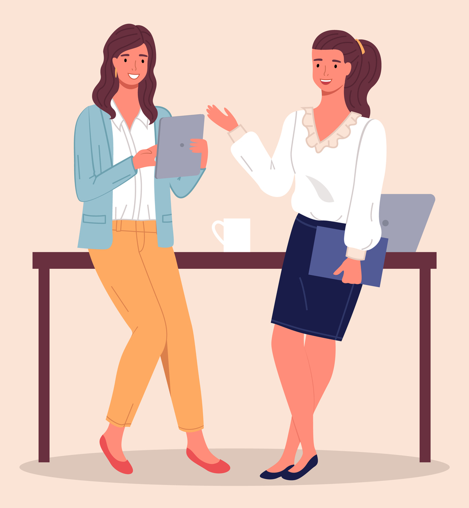 Two modern women, office workers, clerks or colleagues communicate, leaning on the table. Woman with tablet in her hand, girl with folder in her hand. Laptop and cup on the table. Coffee break. Two women chatting in the office during a coffee break. Office staff, colleagues, employees