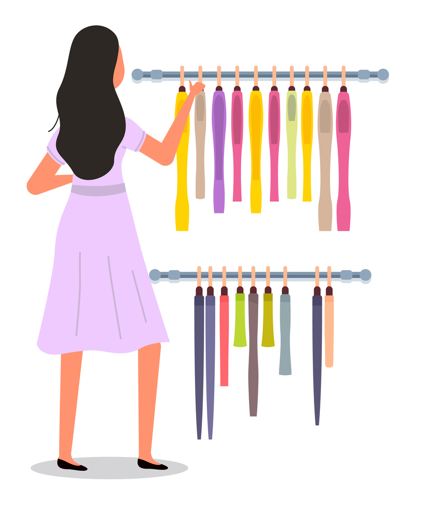The girl is choosing colored garment on hangers. The young fashion woman in dress isolated on white background. Buyer is selecting clothes in a store. Shopper during the sale. Rack with clothing items. The girl is choosing colored garment on hangers. The woman in dress isolated on white background