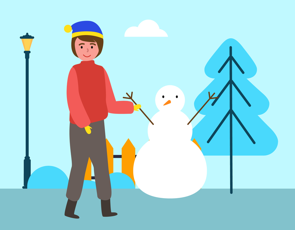 A male child is walking on the street and playing with the snow. Happy boy in warm clothes is standing against the background of a snowy tree. Male character on the street is sculpting a snowman. A male child walks on the street and plays with the snow. Boy in winter clothes sculpts a snowman