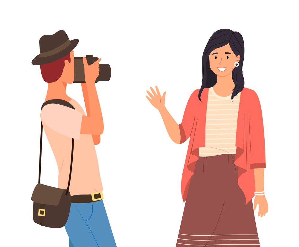 Man photographer makes a photo of a young smiling girl. Stylish professional camerist with a modern camera takes a picture of pretty happy woman waving hand, Portrait shooting beautiful girl. Man photographer makes a photo of a young smiling girl. Stylish camerist with a modern camera