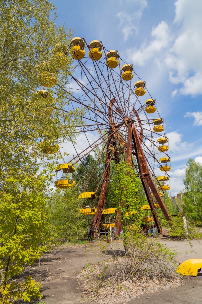 Old broken rusty metal radioactive electric wheel abandoned, the park of culture and recreation in the city of Pripyat, the Chernobyl disaster, Ukraine.