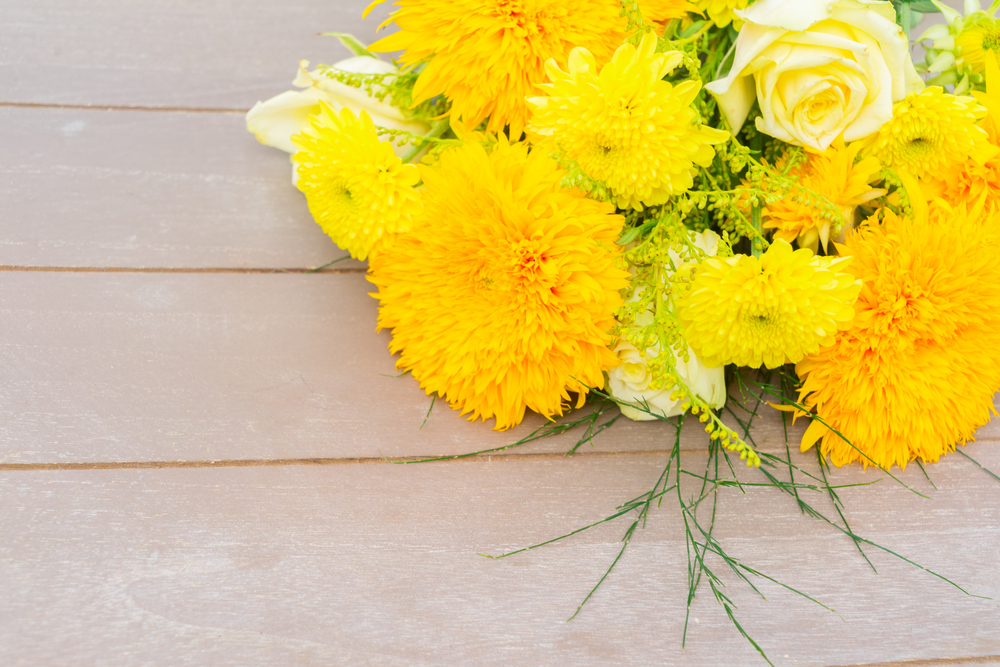 Yellow fall bouquet on gray wooden table with copy space. Yellow fall bouquet