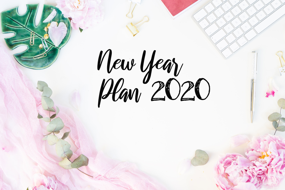 New 2020 year plan with modern keyboard with female accessories and peony flowers, copy space on white background. Top view home office workspace