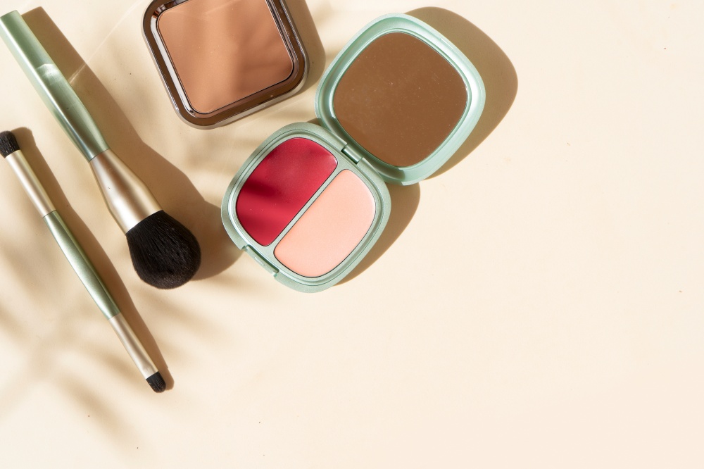 Minimal modern cosmetic scene with make up brushes, blush, powder and shadow overlay. make up brushes