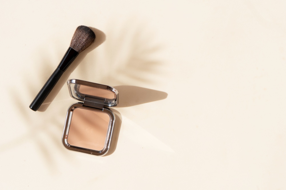 Minimal modern cosmetic scene with make up brushes, powder and shadow overlay. make up brushes