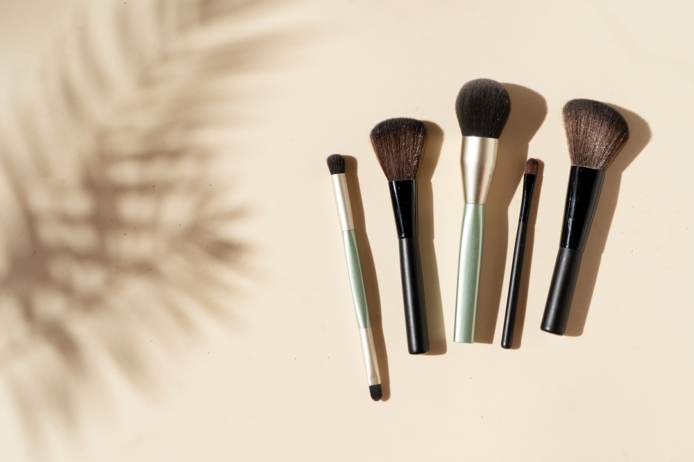 Minimal modern cosmetic scene with make up brushes set and shadow overlay. make up brushes