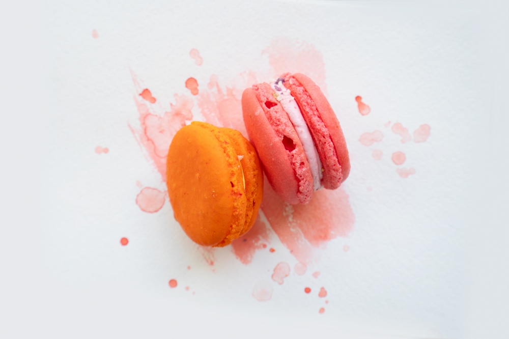 pair of french cookies macaroons on watercolor background, top view. french cookies macaroons