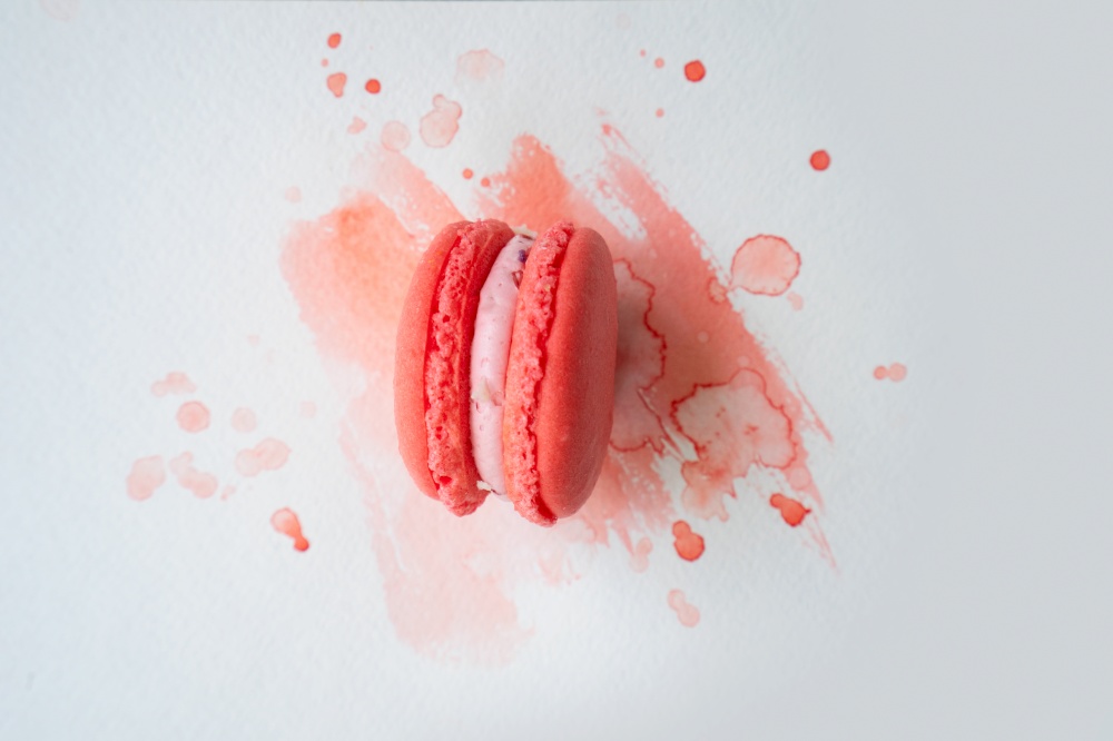 fpink rench cookie macaroon on watercolor background, top view. french cookies macaroons
