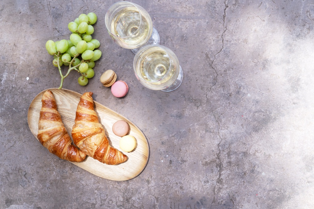 picnic with wine and croissants on concrete table. picnic with wine