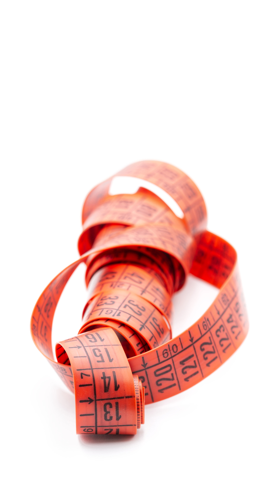 blur red  tape measure in the white light like concept of diet and lenght tool   and copy space