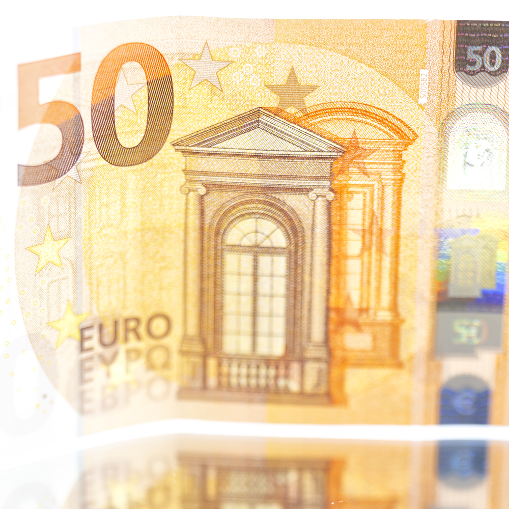 blurred euro money background and mirror like concept of success prosperity and business