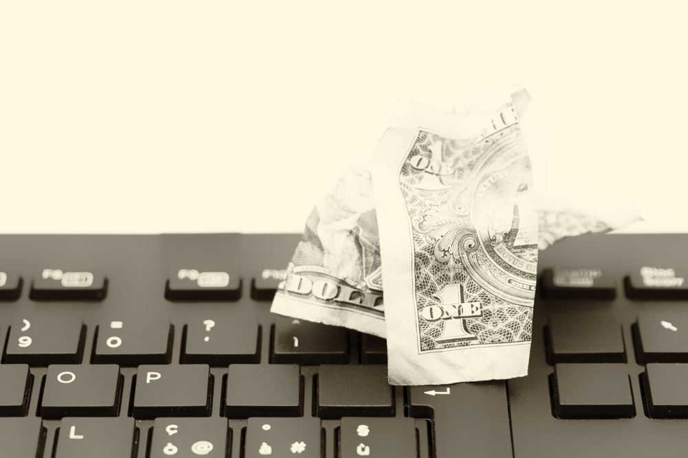 blurred crumpled dollar money background in a keyboard like concept of problem anc copy space