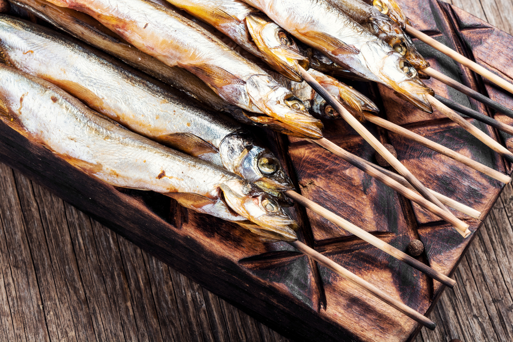 Smoked fish with spices.Cold smoked fish.Smoked capelin. Appetizing smoked fish